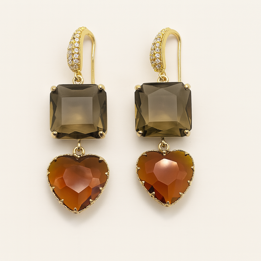 Gold earrings with smoky green and heart-shaped brown stones on a light beige background