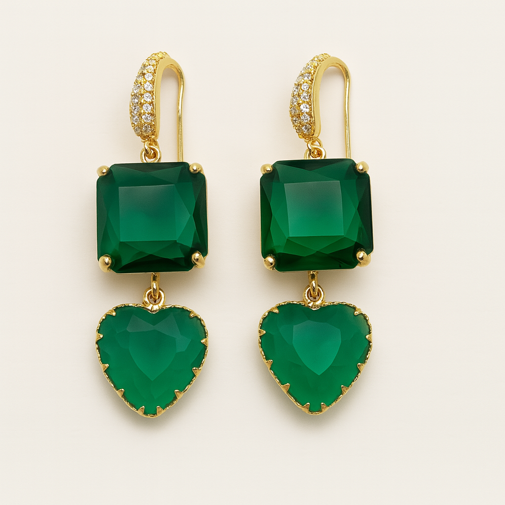 Green gemstone earrings with gold accents on a light beige background