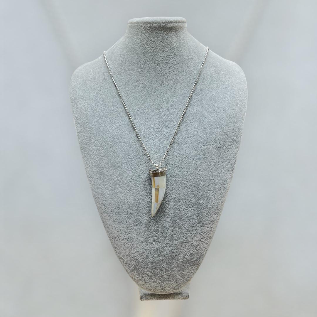 Necklace with a unique pendant on a mannequin bust against a plain background