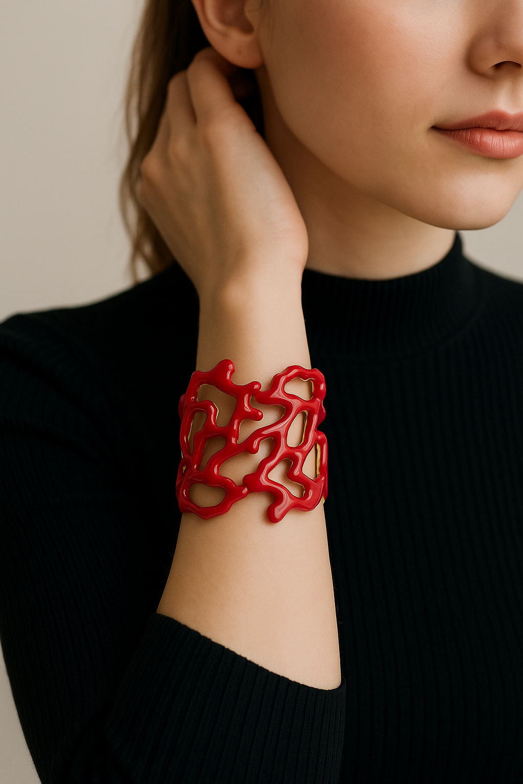 Woman wearing a red bracelet on a neutral background