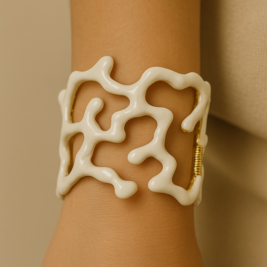White coral-like bracelet on a wrist against a beige background